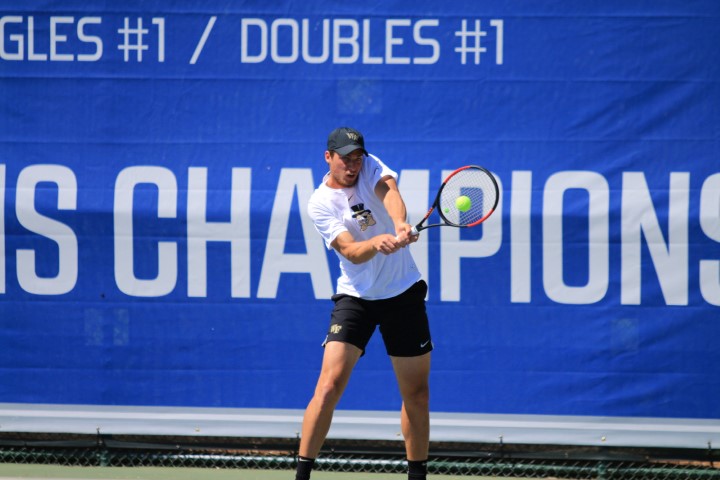 Tennis player hitting ball