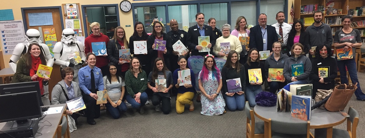 People in a library holding books