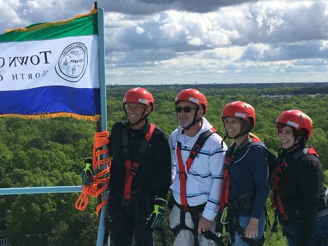 employees preparing to climb a water tank