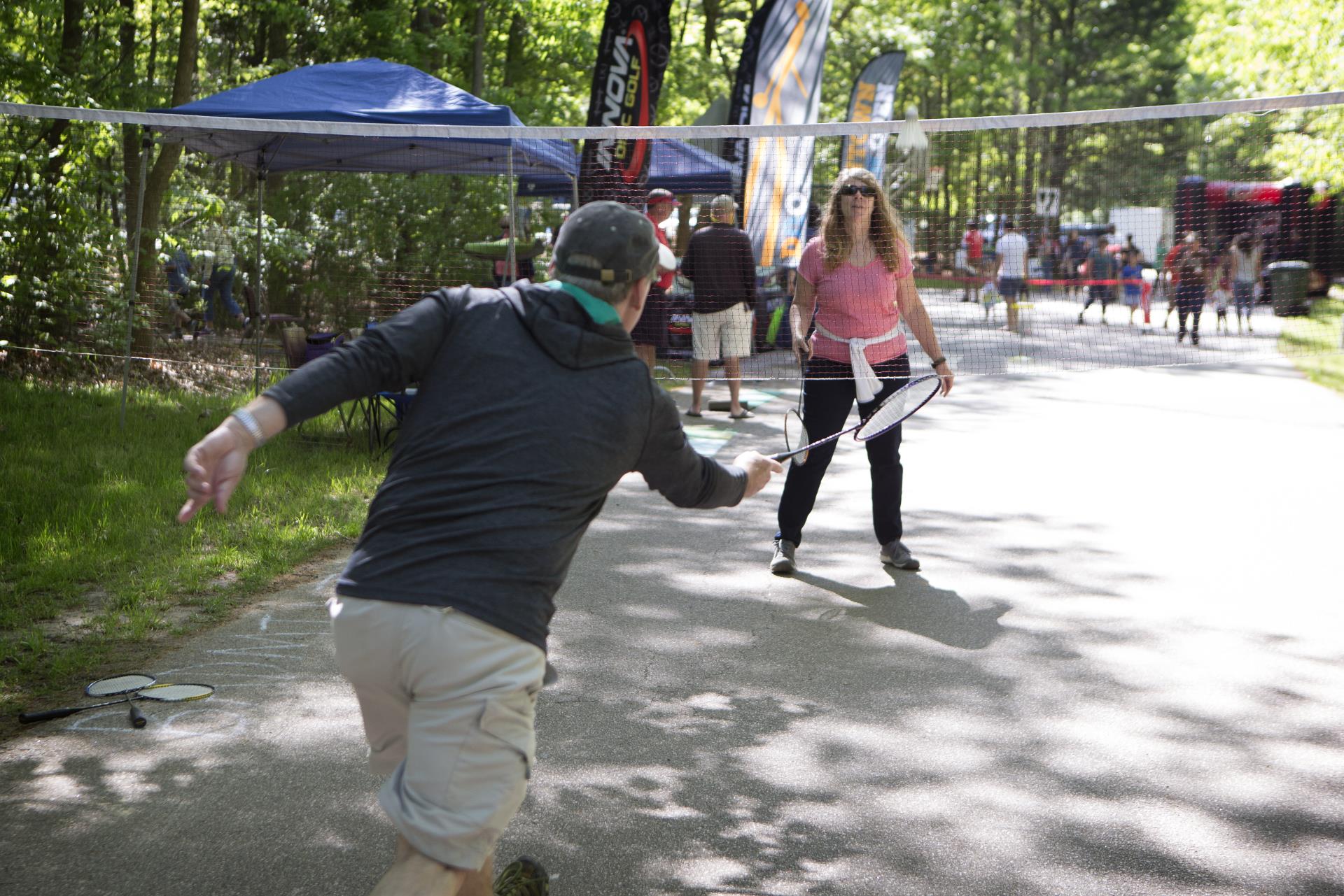 Man and woman playing badminton