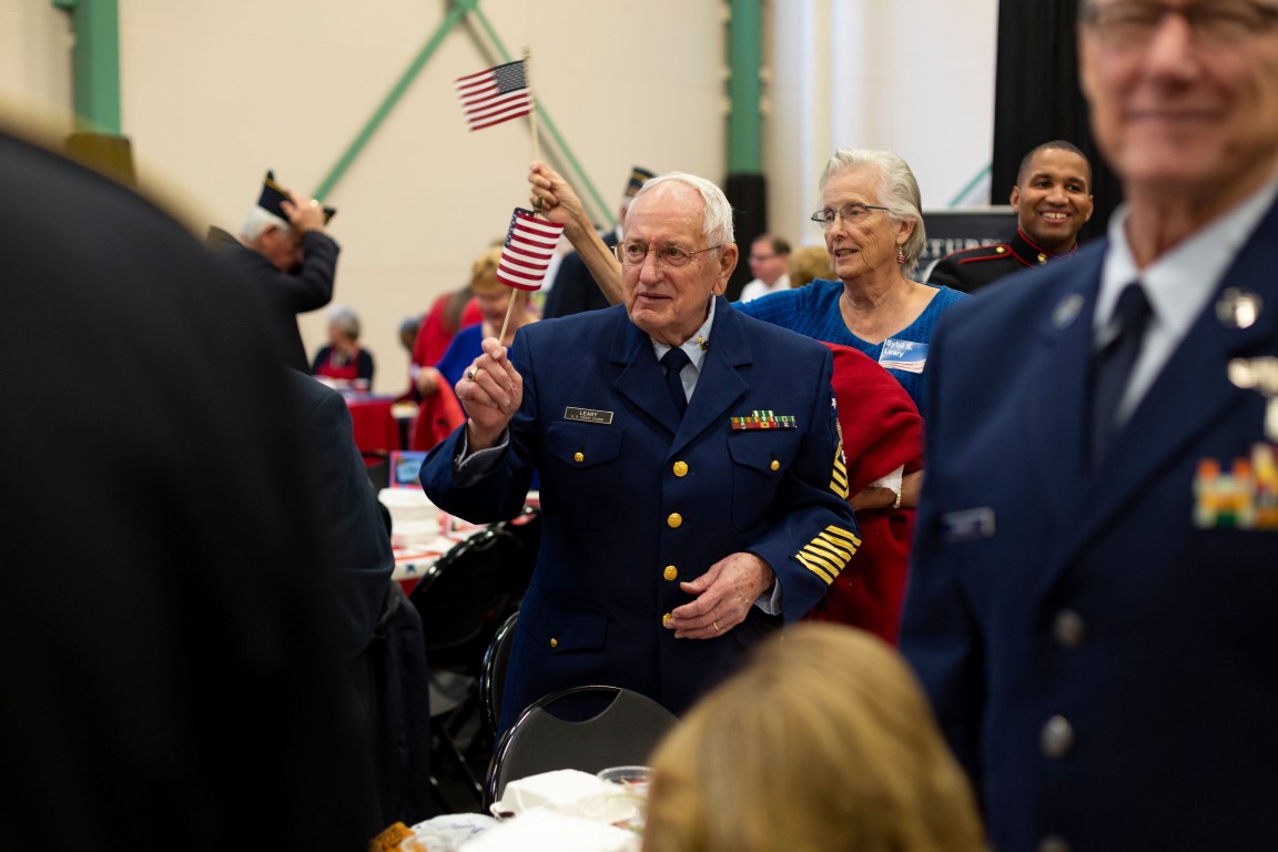 Veterans and families waving American flags