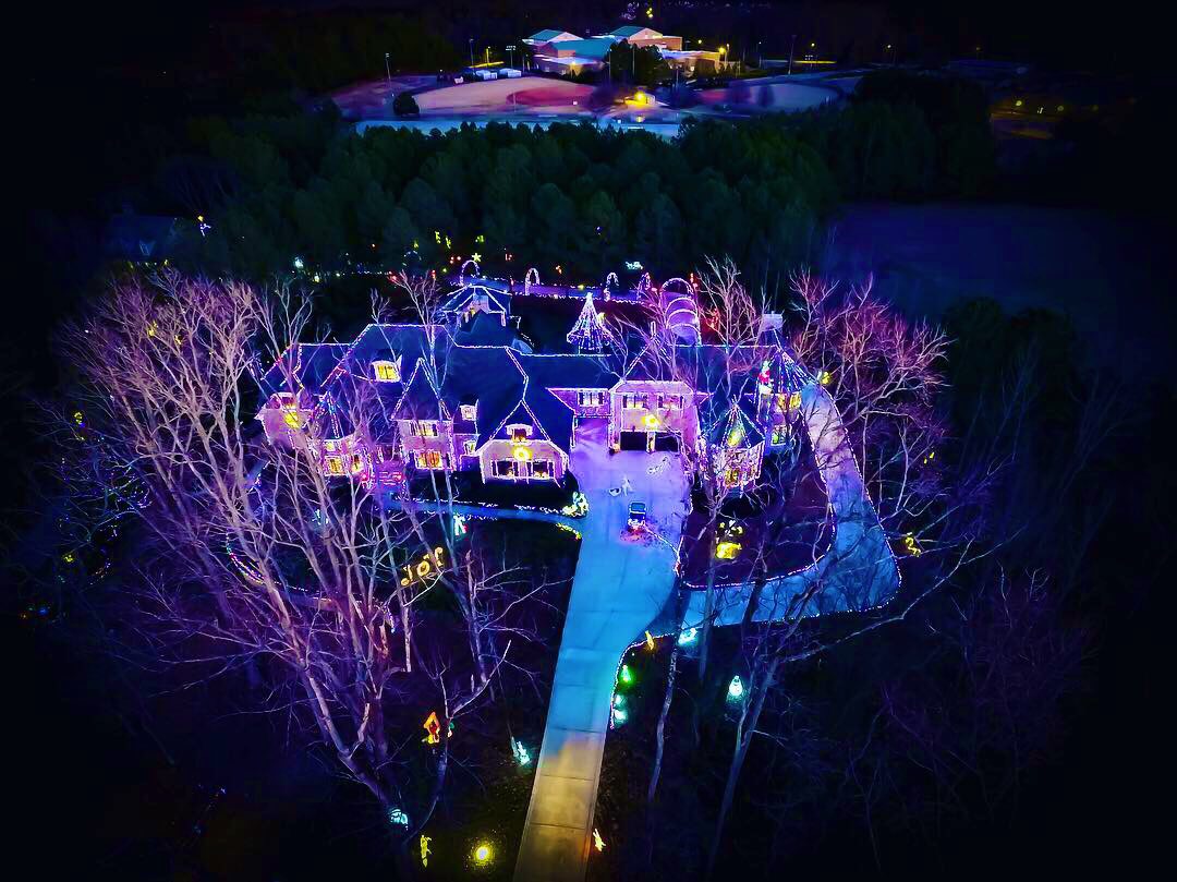 Aerial view of home with christmas lights at night