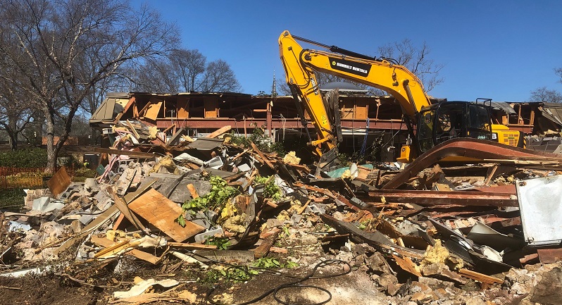 Excavator on pile of rubble at old Library site