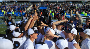 Team celebrating around championship trophy