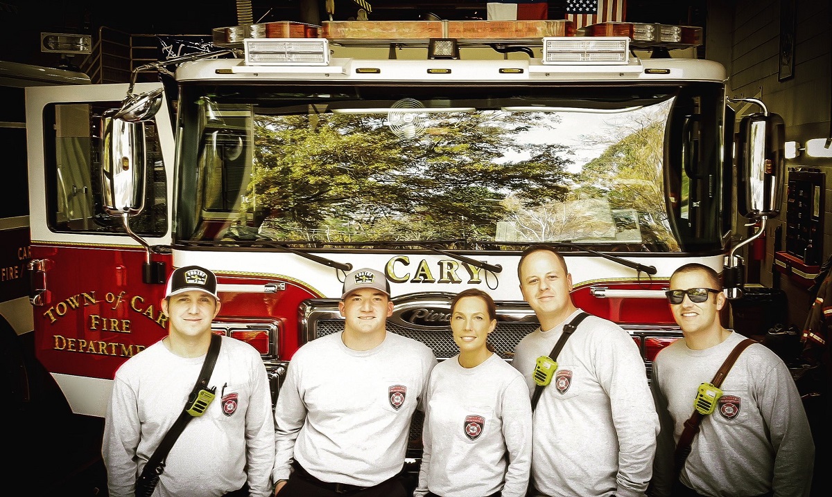 Firefighters in front of fire engine