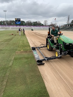 Man tending to WakeMed Stadium Sod