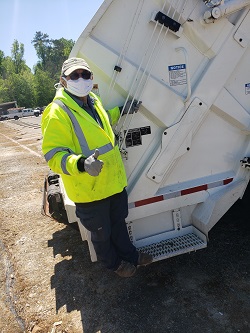 Garbage Collector on back of truck