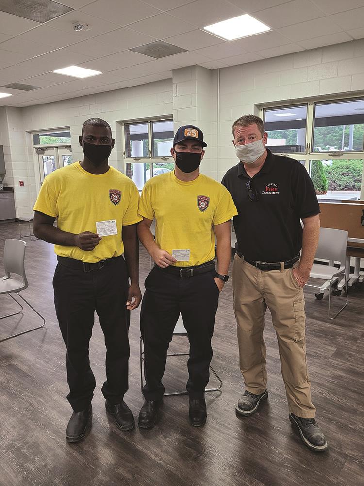 Employees with vaccine cards at clinic