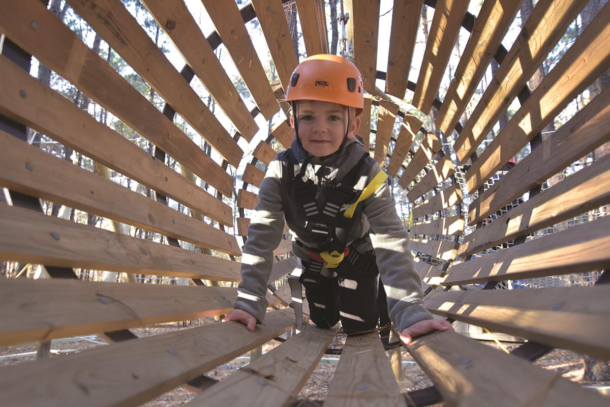 Child playing at Bond Park Challenge Course