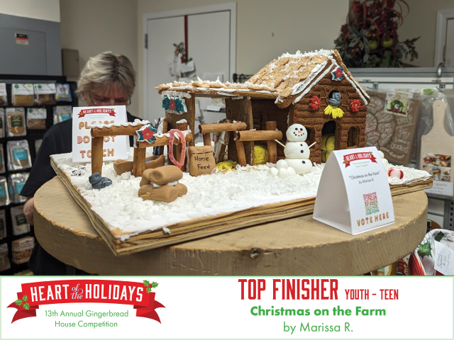 Top finisher in the youth teen category. Christmas on the Farm by Marissa has a log barn filled with hay and horses in the stalls.