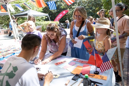 People interacting with a calligrapher