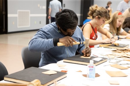 People practicing beginner leatherworking with the Raleigh Leatherworkers Guild